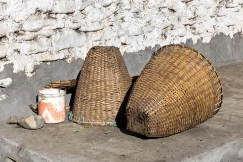 Wicker baskets are in a stone wall Stock Photos