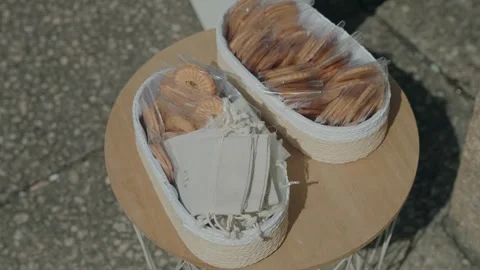 Wicker baskets with packaged biscuits on wooden table Stock Footage 317246867