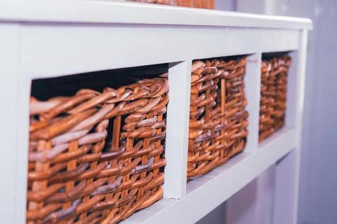Wicker baskets on a shelf in a store, close-up Stock Photos