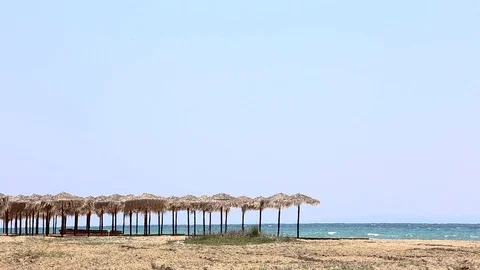 Wicker beach umbrellas by the sea, beach without people, Greece Stock-Footage 114507553