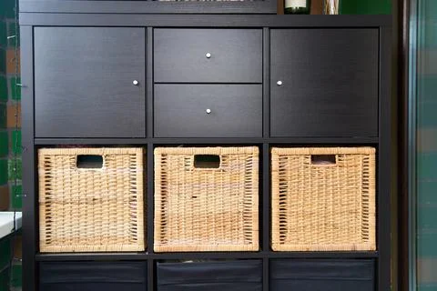 Wicker boxes for things on the shelves. Wardrobe for storage of things Stock Photos