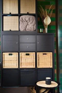 Wicker boxes for things on the shelves. Wardrobe for storage of things Stock Photos