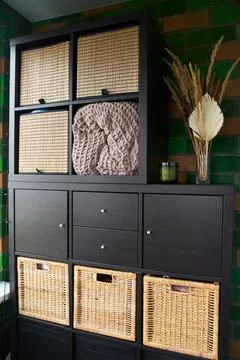 Wicker boxes for things on the shelves. Wardrobe for storage of things Stock Photos