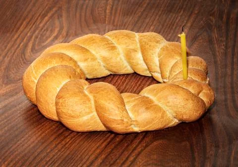 Wicker bread and extinguished candle Stock Photos