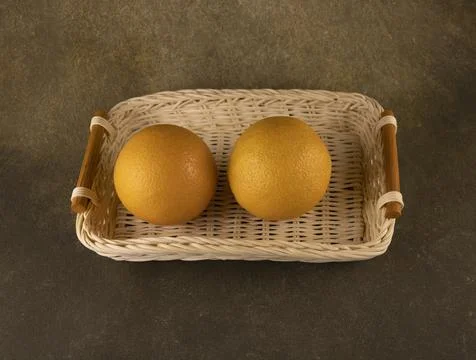 Wicker bread basket tray with two oranges Stock-Fotos
