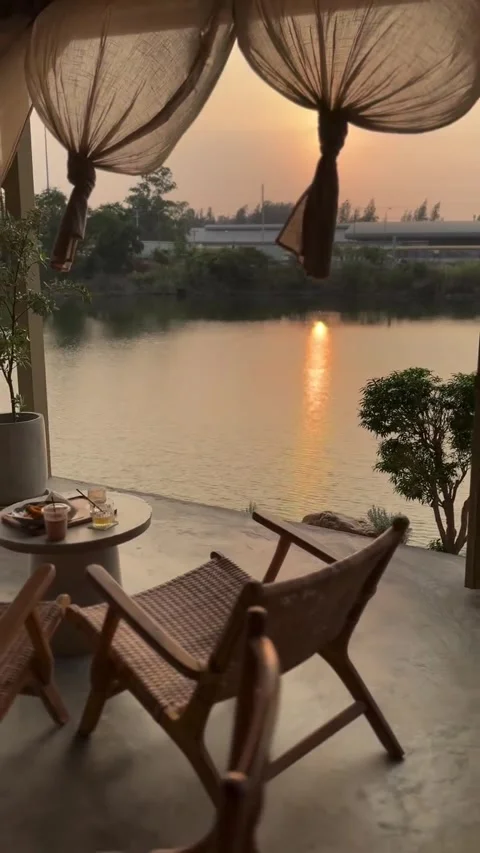 Wicker Chairs on Balcony Overlooking Lake at Sunset Stock Footage 342265282