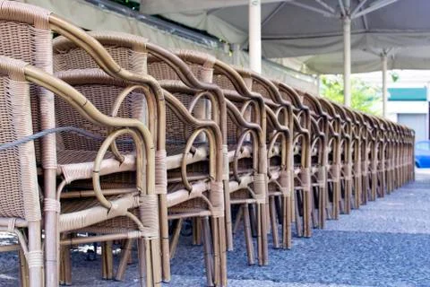 Wicker chairs stand in a row Stock Photos
