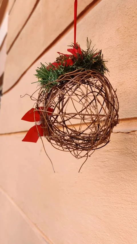 Wicker decorative ball hangs on red ribbon slowly rotates around its axis Stock Footage 327902889