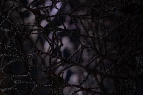 Wicker mesh of threads as a background with a soft blurred focus in the dark  Stock Photos