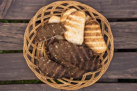 Wicker platter with slices of grilled bread Stock Photos
