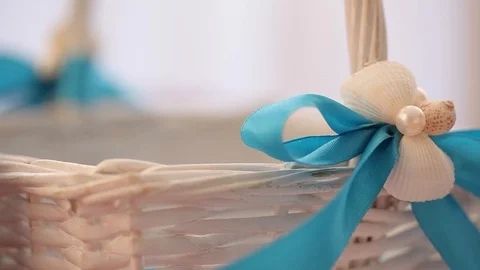 Wicker White Basket with a bow from a blue ribbon Stock Footage 114496423