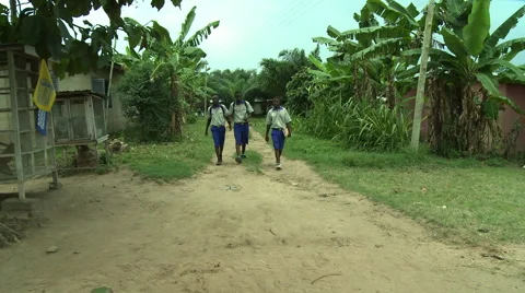 WIDE: ADEISO STUDENTS WALK UP PATH TOWARDS CAMERA Stock Footage 58070295