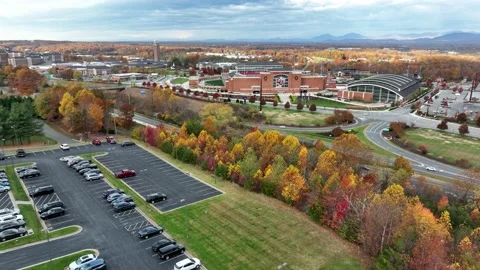 Wide aerial approach of Liberty University during colorful autumn fall Stock Footage