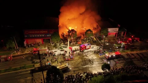 Wide aerial circle around large fire scene at night 스톡 동영상 337346000