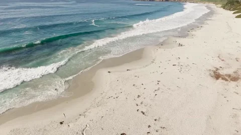 Wide aerial circle pan pulling away from people on the beach Stock Footage 160812360