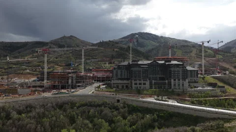 Wide aerial of cranes and construction at Deer valley Utah ski resort stormy sky Stock Footage 335799400