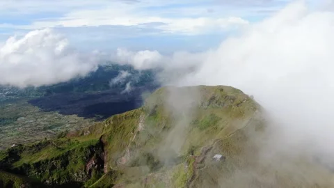 Wide Aerial Drone Fly through clouds Mount Batur bali Video stock 330472895