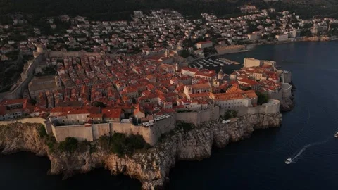 Wide Aerial Drone Pan Right of Dubrovnik Walled Old City Cliffs Sunset 4K Stock Footage 337850153