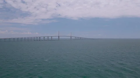Wide aerial drone push toward Sunshine Skyway Bridge over Tampa Bay Stock Footage 335475273
