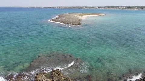 Wide aerial drone shot of Mare Torre Squillace, Heart Isle, Porto Cesareo, Italy Stock-Footage 241654331