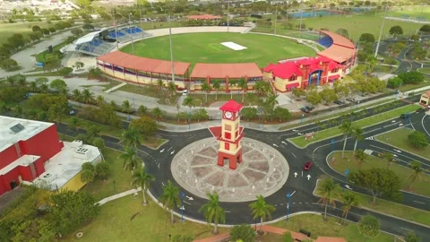 Wide Aerial Drone View Of Red Roof Sports Stadium And Clock Tower In Lauderhill Stock Footage 339064685