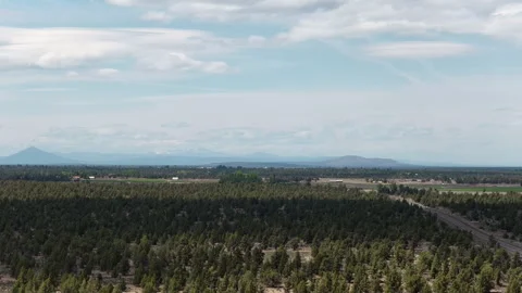 Wide aerial of eastern Bend Oregon rural homes with mountain view in spring Stock Footage 335728185