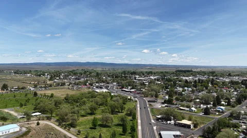 Wide aerial of eastern Oregon town of Burns in spring on sunny day Stock Footage 335726767
