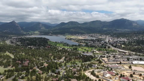 Wide aerial of Estes Park small town with Lake Estes and Rocky Mountains Stock Footage 337137737