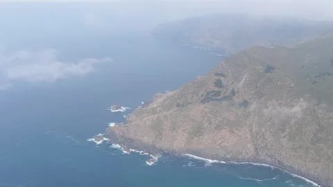 Wide aerial footage capturing the dramatic rocky coastline and steep cliffs Stock Footage 346719441