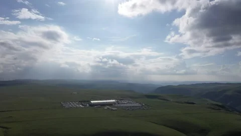 Wide Aerial Of Inner Mongolia Steppe With Wind Turbines And Storm Clouds 01 Stock Footage 337810025