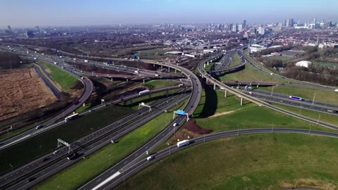 Wide aerial of intricate multi layer freeway crossing with Dutch city The Hague Stock Footage 332628005