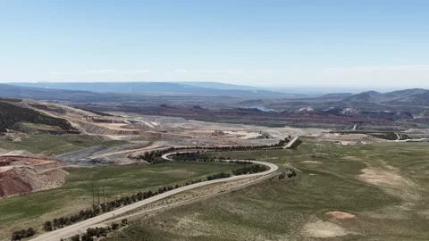 Wide aerial of mining operations and highway in Vernal Utah in spring Stock Footage 335836270