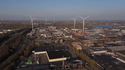 Wide aerial orbit of wind turbines and logistics hub Stock Footage 335658664