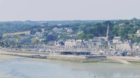 Wide aerial panning shot of Binic, a coastal town, showing the marina with Stock Footage 346697953