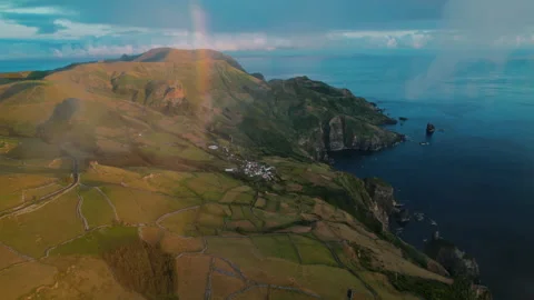 Wide aerial panorama of a dramatic volcanic coastal landscape at golden hour Stock-Footage 335711496