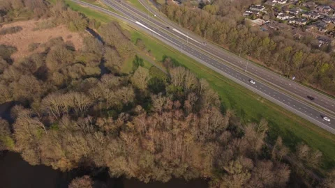 Wide aerial pullback reveal of wind turbines, highway and port Stock Footage 335651751