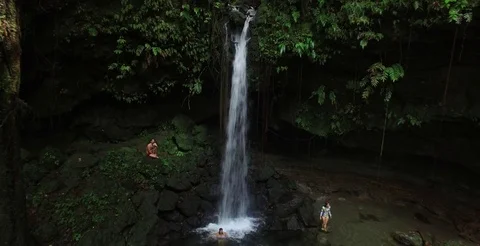 Wide aerial pulling back on Emerald Pool waterfall in Dominica Stock-Footage 69955579