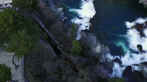 Wide aerial pushing down towards rushing river and waterfall Stock Footage 155464144