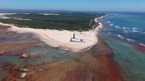 Wide Aerial Shot of Lighthouse, Coastline, Landscape, and Distant Cityscape Stock Footage 306304053