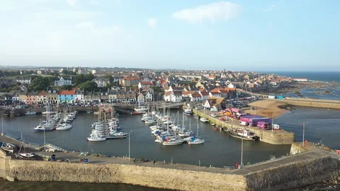Wide aerial shot looking over Anstruther town and harbour, Scotland Stock Footage