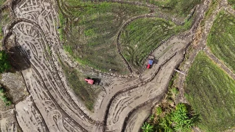 Wide aerial top down of two tractors plowing muddy agricultural fields. Stock Footage 340515196