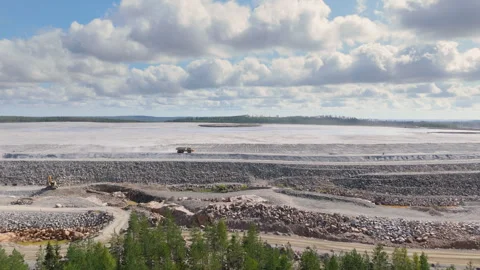 Wide aerial tracking shot of mining dump truck transporting aggregate material Video stock 299665709