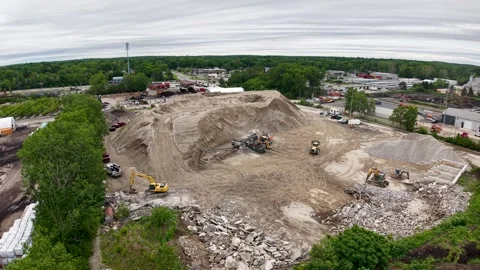 Wide aerial view of an aggregate quarry complex surrounded by trees and nearby Stockbeeldmateriaal 341101588