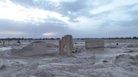 Wide Aerial View of Ancient Mud Brick Gate, Pise Wall, and Sunset Glow at Stock Footage 345523869