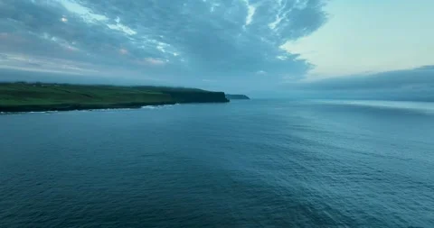 Wide aerial view of Cliffs of Moher coastline with low clouds over Atlantic Stock Footage 339506582