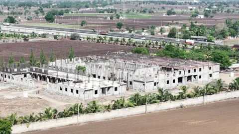 Wide Aerial View of Construction Site Development Surrounded by Cultivated Stock Footage 340383361