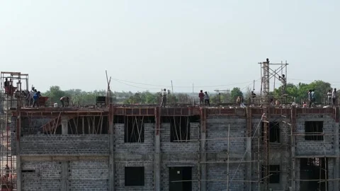 Wide Aerial View of Construction Workers Building Multi-Story Structure with Stock Footage 340564297