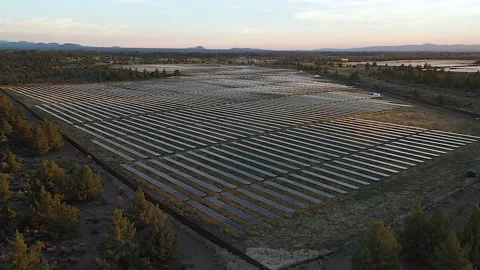 Wide aerial view drone over solar farm near Bend, OR at dusk Stock Footage 160932095