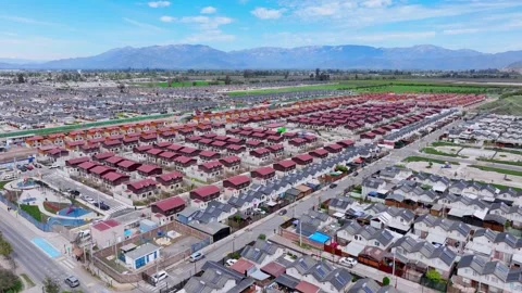 Wide aerial view of endless rows of red and grey roofed houses in a massive Видео 348246693