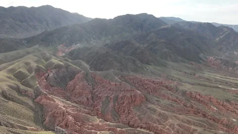 Wide aerial view of an eroded red canyon, Kok-Moinok Canyons, Kyrgyzstan Stock Footage 347239749